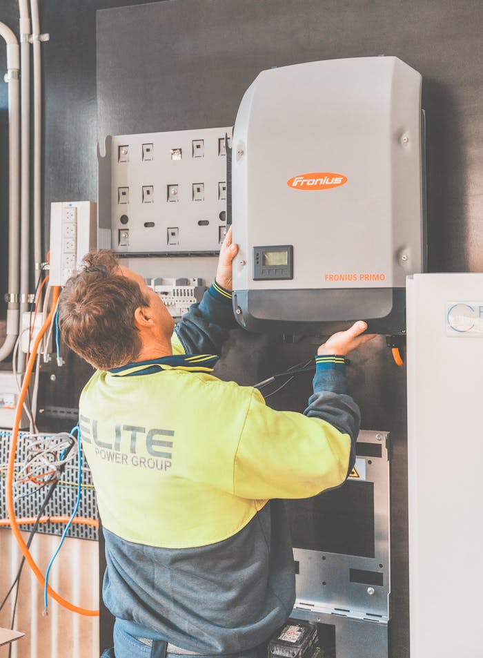Expert technician setting up a solar inverter in Thornton, NSW, ensuring efficient solar energy flow.